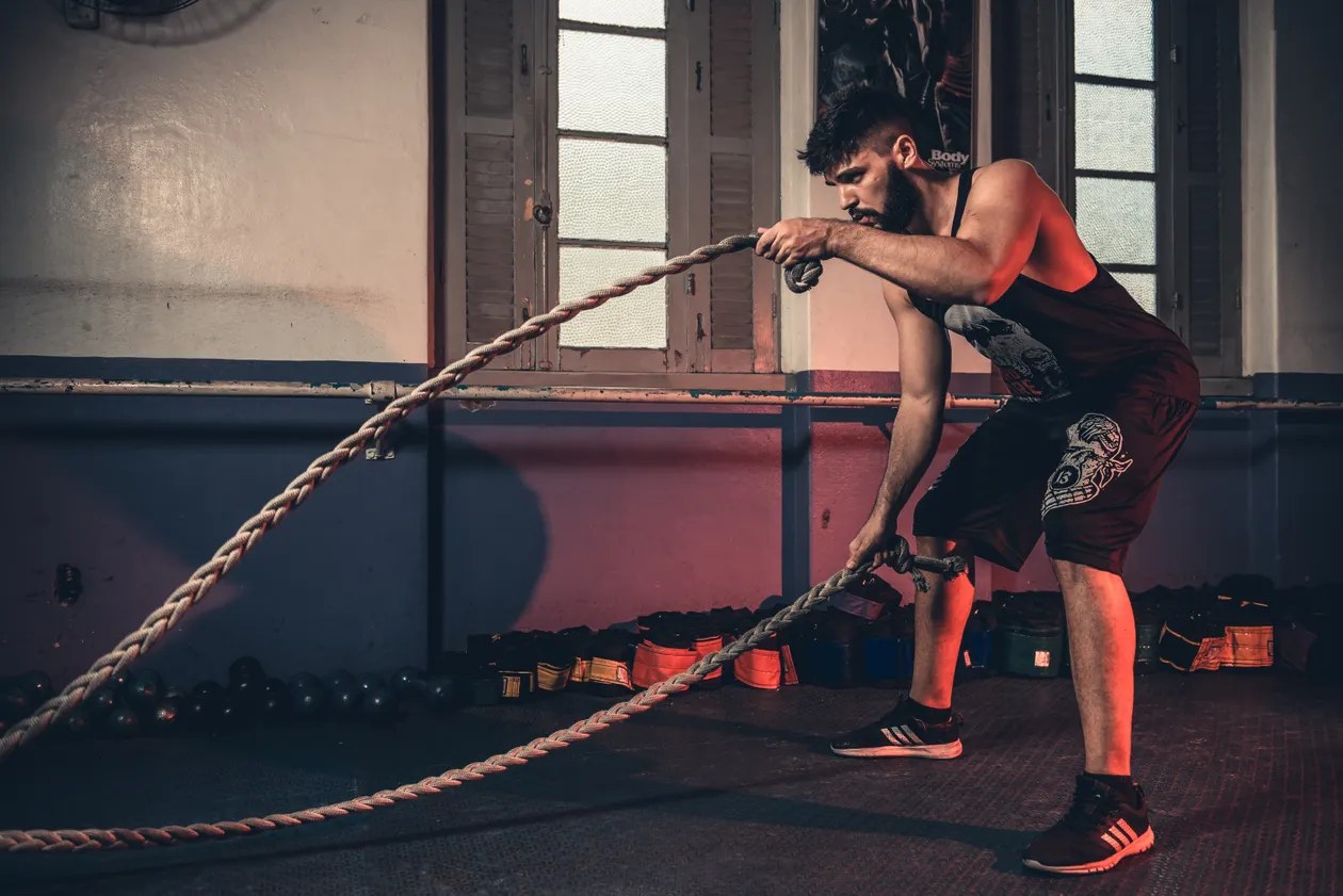Athlete working through battle-rope training